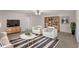 Comfortable living space with a large TV, a stylish rug and two cozy armchairs at 364 Fish Hawk Dr, Winter Haven, FL 33884