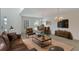 Bright living room and dining area with modern furnishings, a large window, and an elegant chandelier at 364 Fish Hawk Dr, Winter Haven, FL 33884