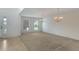 Expansive living room with tile and carpet flooring with large windows and chandelier lighting at 364 Fish Hawk Dr, Winter Haven, FL 33884