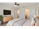 Inviting bedroom features a ceiling fan, closet access and a connected bathroom at 364 Fish Hawk Dr, Winter Haven, FL 33884