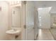 Powder room featuring pedestal sink, mirror, and neutral flooring at 364 Fish Hawk Dr, Winter Haven, FL 33884