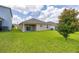Spacious backyard with lush green grass and a covered patio, perfect for outdoor enjoyment at 371 Pinecrest Loop, Davenport, FL 33837