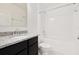 Clean bathroom featuring granite countertop, vanity, and a shower-tub combo at 371 Pinecrest Loop, Davenport, FL 33837