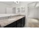 Bright bathroom featuring a double vanity with granite countertops and modern fixtures at 371 Pinecrest Loop, Davenport, FL 33837