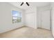 Cozy bedroom featuring neutral carpet, a ceiling fan, closet, and a window at 371 Pinecrest Loop, Davenport, FL 33837