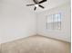 Bright bedroom with neutral carpet, a ceiling fan, and a large window at 371 Pinecrest Loop, Davenport, FL 33837