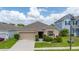 Single-story home showcasing manicured lawn, complemented by a two-car garage at 371 Pinecrest Loop, Davenport, FL 33837