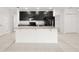 Kitchen island with white cabinets, granite countertops and stainless steel appliances at 371 Pinecrest Loop, Davenport, FL 33837