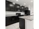 Beautiful kitchen featuring black cabinetry, granite countertops, and stainless steel appliances at 371 Pinecrest Loop, Davenport, FL 33837