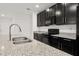 Kitchen sink featuring granite countertops, stainless steel appliances, and black cabinets at 371 Pinecrest Loop, Davenport, FL 33837