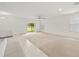 Bright, open-concept living area with neutral carpet and tile, ceiling fan, and sliding glass doors at 371 Pinecrest Loop, Davenport, FL 33837