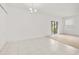 Bright living room with neutral tones and sliding glass doors to the outside at 371 Pinecrest Loop, Davenport, FL 33837