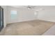Bright living room with neutral carpet, fan, windows, and sliding glass door at 371 Pinecrest Loop, Davenport, FL 33837