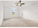 Bright main bedroom with a tray ceiling, ceiling fan, and carpet at 371 Pinecrest Loop, Davenport, FL 33837