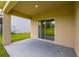 Covered patio with a view of the backyard through sliding glass doors at 371 Pinecrest Loop, Davenport, FL 33837