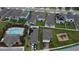 Aerial view of a neighborhood with homes that have solar panels, community pool, and playground at 3839 Marbella Way, Davenport, FL 33897