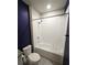 Bathroom with white tiled shower and bathtub, complemented by a toilet and stylish fixtures at 3839 Marbella Way, Davenport, FL 33897