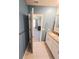 Bathroom with granite vanity, white cabinet, and blue wall paint at 3839 Marbella Way, Davenport, FL 33897