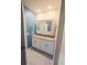 Bright bathroom with a double sink vanity, granite countertop, and storage at 3839 Marbella Way, Davenport, FL 33897