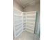 Walk-in closet with built-in shelving for efficient storage and organization at 3839 Marbella Way, Davenport, FL 33897