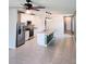 Bright, open kitchen with stainless steel appliances and an island with a sink at 3839 Marbella Way, Davenport, FL 33897
