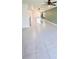 Open-concept kitchen featuring a large island with modern lighting and tiled floor at 3839 Marbella Way, Davenport, FL 33897