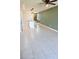 Open-concept kitchen featuring a large island with modern lighting and tiled floor at 3839 Marbella Way, Davenport, FL 33897