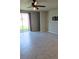 Bright and spacious living room with tile flooring and a sliding glass door to the backyard at 3839 Marbella Way, Davenport, FL 33897