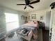 Inviting bedroom with large window, comfortable bed, and decorative accents at 421 Bridle Path, Casselberry, FL 32707