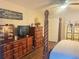 Spacious bedroom with dressers, wood floors, and a love story decor piece at 421 Bridle Path, Casselberry, FL 32707