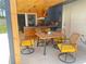 Outdoor dining area with a wooden table, chairs, and built-in grill under a covered patio space at 421 Bridle Path, Casselberry, FL 32707