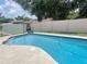 Inviting backyard pool with a waterfall feature, offering a serene and relaxing oasis for summer enjoyment at 421 Bridle Path, Casselberry, FL 32707
