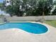 Private backyard with a sparkling pool, surrounding patio, and lush greenery, ideal for outdoor enjoyment at 421 Bridle Path, Casselberry, FL 32707