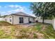 Spacious backyard features a patio, lush grass, and a privacy fence, perfect for outdoor enjoyment and relaxation at 447 Hammerstone Ave, Haines City, FL 33844