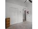 Cozy bedroom with carpet features a double closet for storage and a door with a decorative floral wreath at 447 Hammerstone Ave, Haines City, FL 33844
