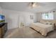 Spacious bedroom featuring plush carpet, a ceiling fan, and a comfortable bed, creating a relaxing retreat at 447 Hammerstone Ave, Haines City, FL 33844