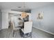 Elegant dining room with a modern light fixture and stylish decor and open to the kitchen at 447 Hammerstone Ave, Haines City, FL 33844