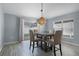 Bright dining room with sliding glass doors, contemporary light fixture, and wood-look tile flooring at 447 Hammerstone Ave, Haines City, FL 33844