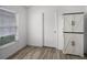 Clean bonus room with wood-look floors, natural light, and a wardrobe-style storage at 447 Hammerstone Ave, Haines City, FL 33844