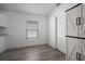 Bright bonus room with wood-look floors, white trim, and a closet or pantry at 447 Hammerstone Ave, Haines City, FL 33844