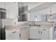 Functional kitchen featuring white cabinets, a built-in dishwasher, and an open layout at 447 Hammerstone Ave, Haines City, FL 33844