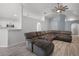 Spacious living room featuring a large sectional sofa, vaulted ceilings, and wood-look flooring at 447 Hammerstone Ave, Haines City, FL 33844