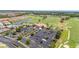 Wide aerial view showcases the clubhouse, parking, and lush green golf course and landscaping at 4928 Cortland Dr, Davenport, FL 33837