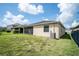 Spacious backyard featuring lush green grass and screened-in porch with natural light at 4928 Cortland Dr, Davenport, FL 33837