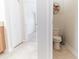 Half bathroom showing decorative accents, tile flooring, and a view into an adjacent room at 4928 Cortland Dr, Davenport, FL 33837