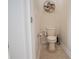Cozy half-bathroom features tile floors and decorative shelving with greenery at 4928 Cortland Dr, Davenport, FL 33837
