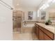 Bright bathroom featuring a glass shower, garden tub, double vanity and granite counter tops at 4928 Cortland Dr, Davenport, FL 33837