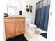 Bathroom featuring a vanity with granite counters, toilet and shower with dark curtain at 4928 Cortland Dr, Davenport, FL 33837