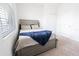 Cozy bedroom with a bed and gray wood headboard, soft carpeting, and bright natural light at 4928 Cortland Dr, Davenport, FL 33837
