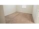 Simple bedroom featuring neutral carpet and a window providing natural lighting at 4928 Cortland Dr, Davenport, FL 33837